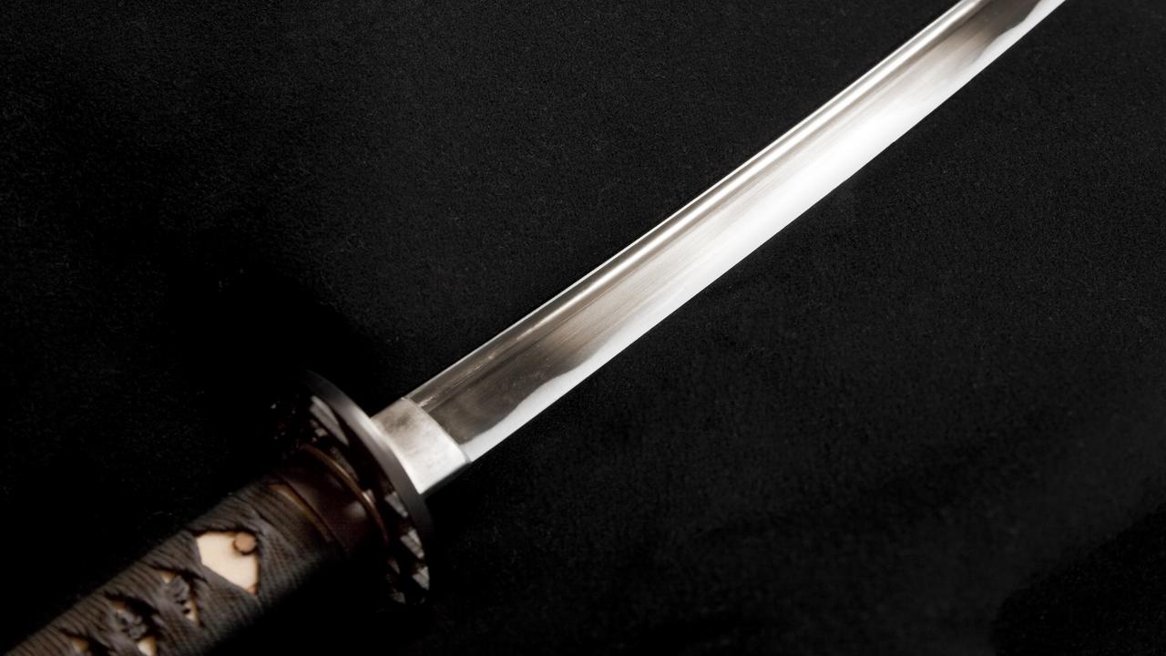 Threatens people with samurai sword