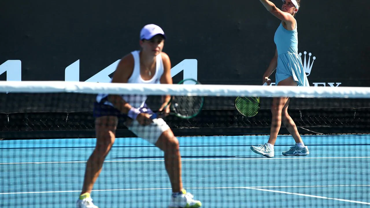 World number one has taken to the court with a heavily strapped thigh for a doubles match at the Australian Open
